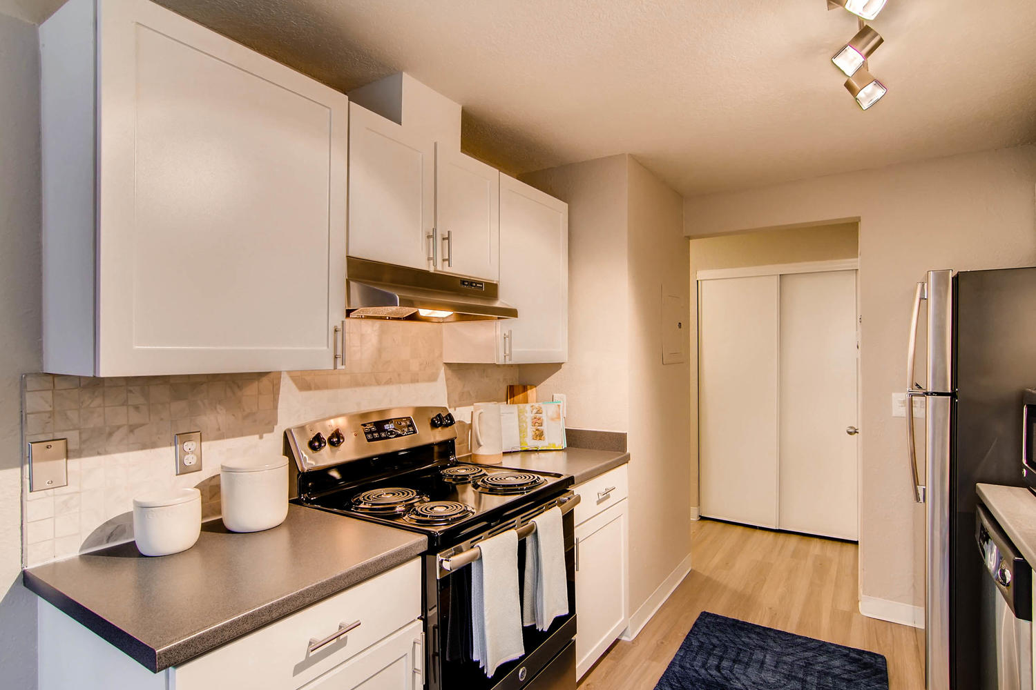 Kitchen with stainless steel appliances and tile backsplash