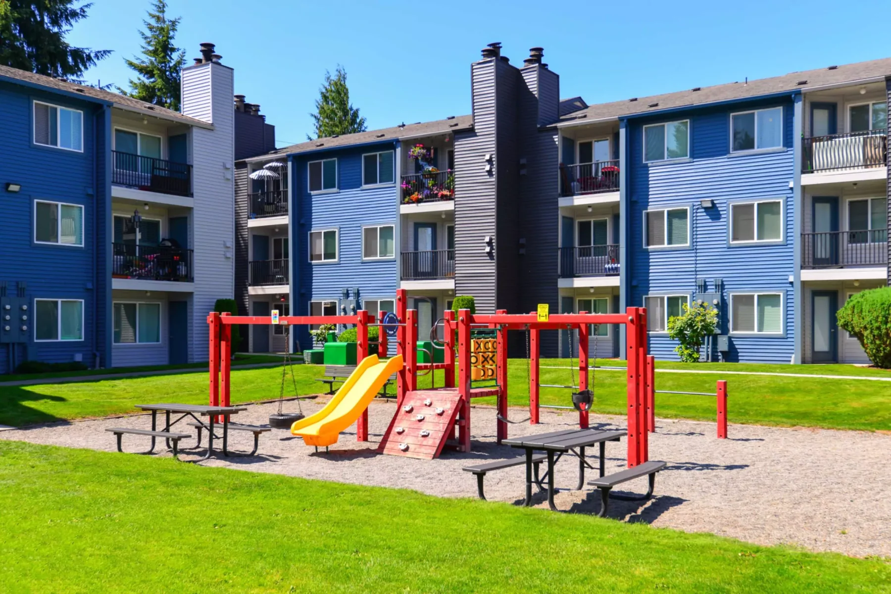 Children's playground with slide, swings, and climbing bars